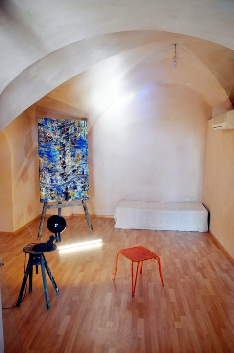 Two works under the stone arch of the artist's studio